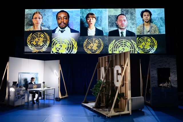 THE VILLAGE: the cast from five cities on screen above the set